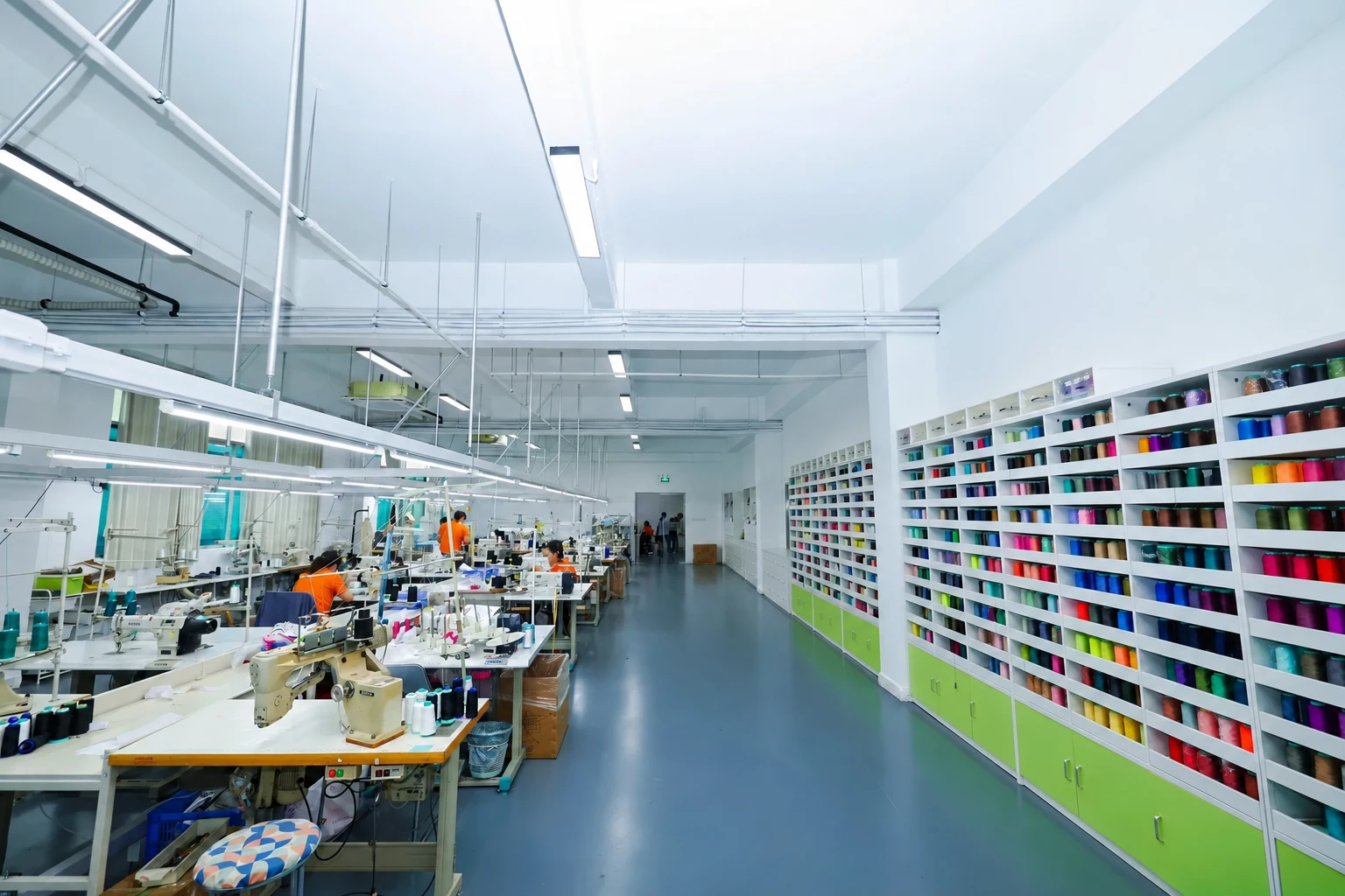 Garment sample workroom with sewing stations and thread references